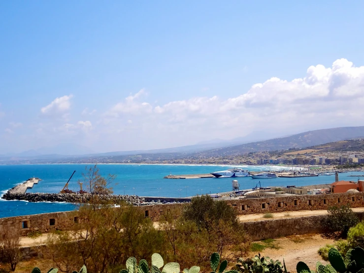 a view of an ocean from atop the hill