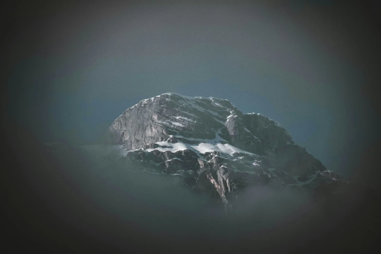 a very tall snow covered mountain in the dark