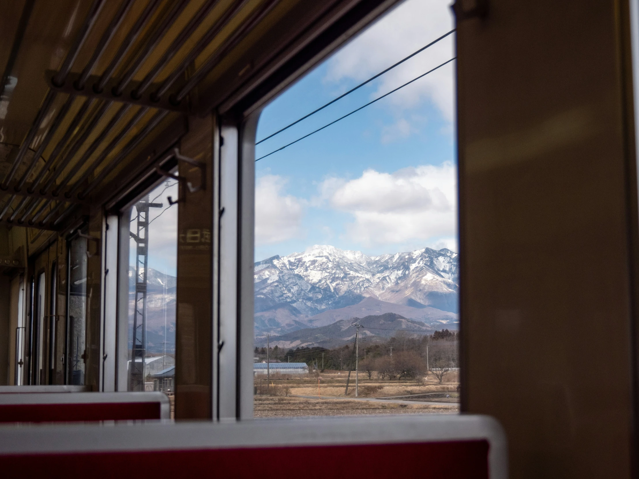 a po of mountains taken from the inside of a train