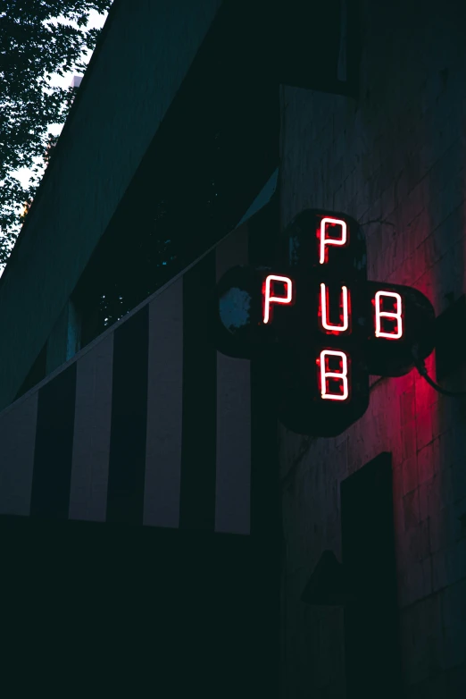 a neon sign reading pub on the corner