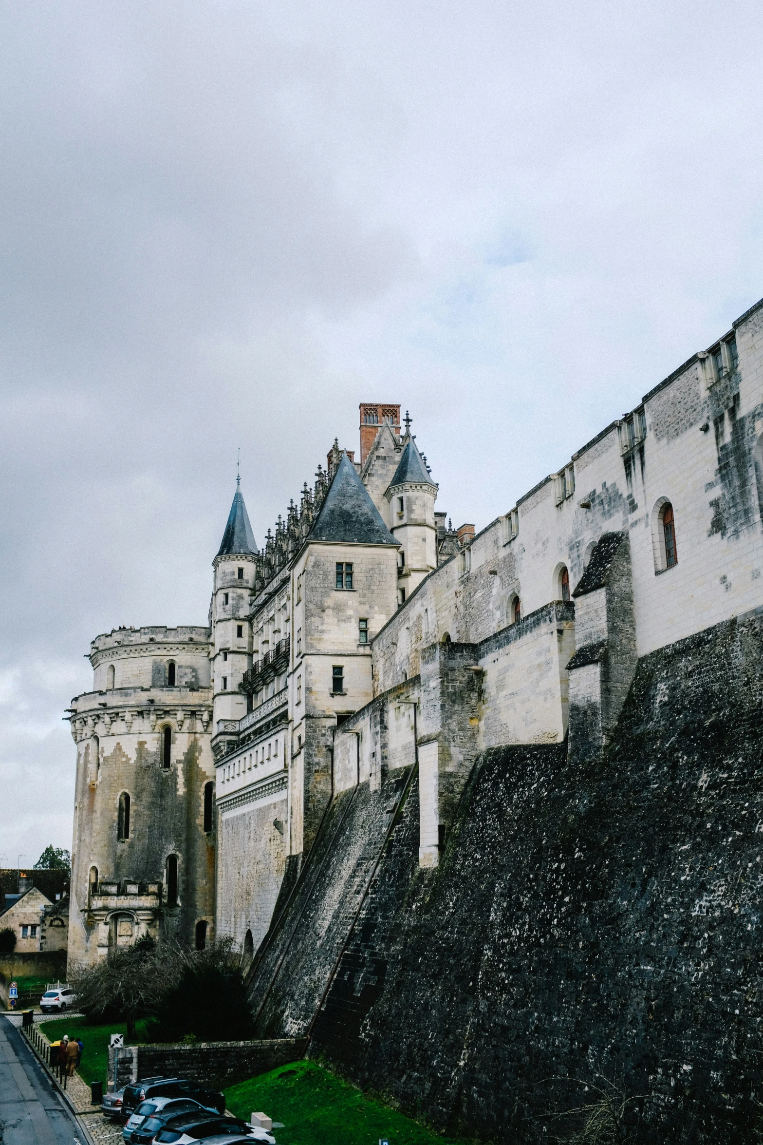 this is a castle wall with cars parked on the side