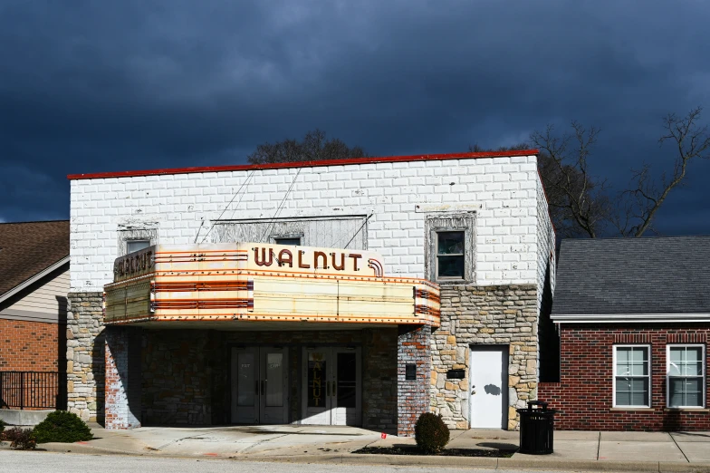 the old theater has its marquee out, and there are storm clouds