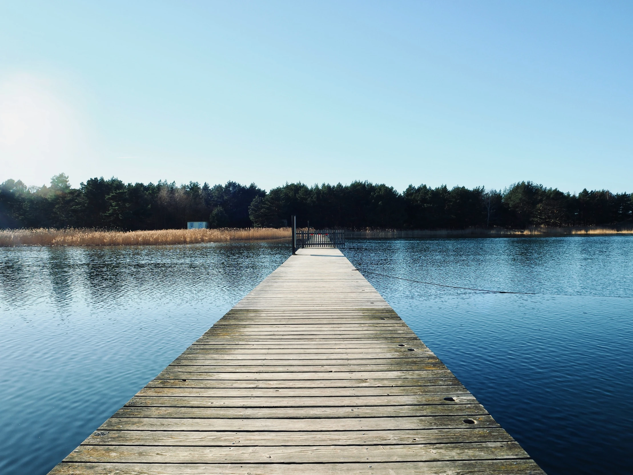 a small wooden pier extends into the water