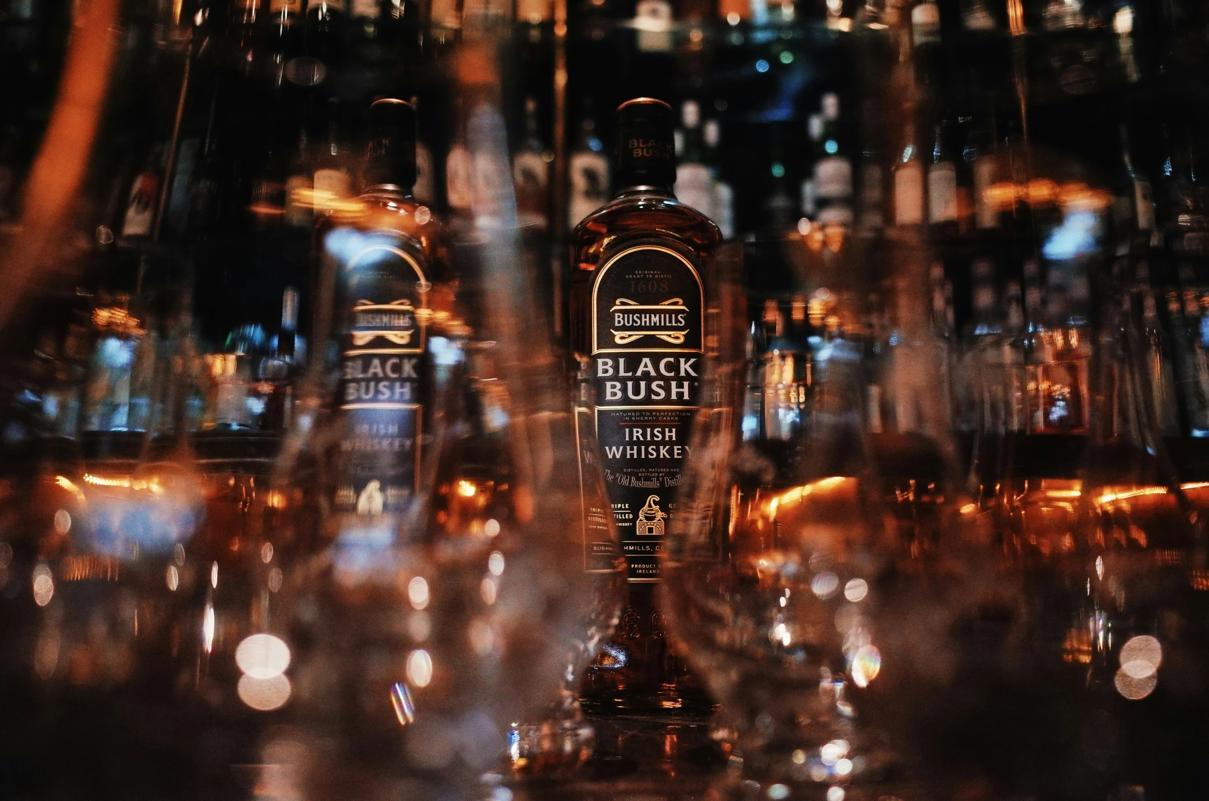 three bottles of whiskey are sitting on a table