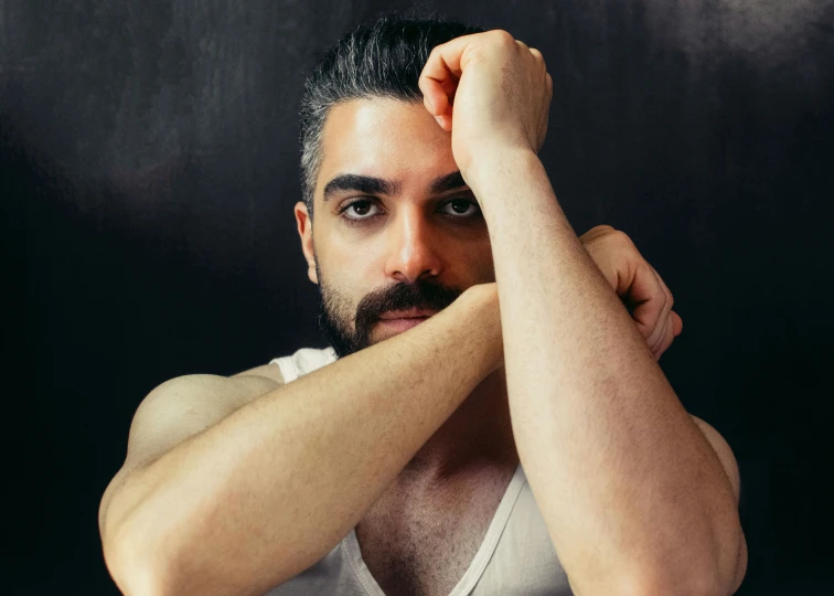 a bearded man is posing for a portrait