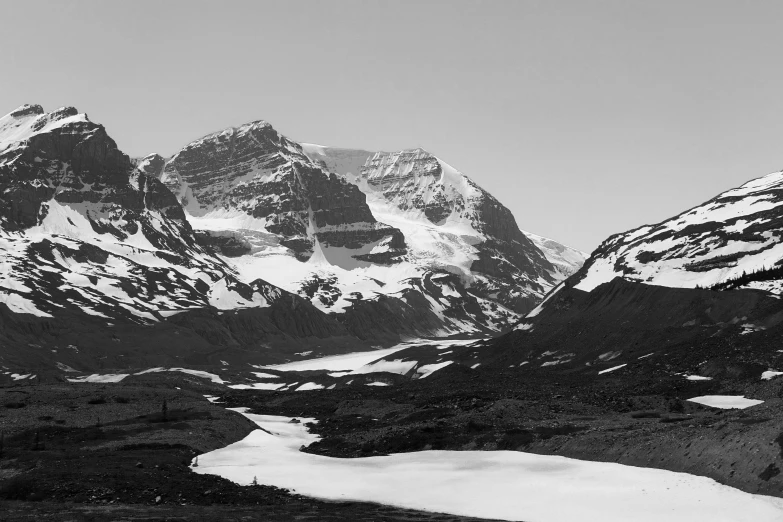 a black and white image of a mountain covered in snow