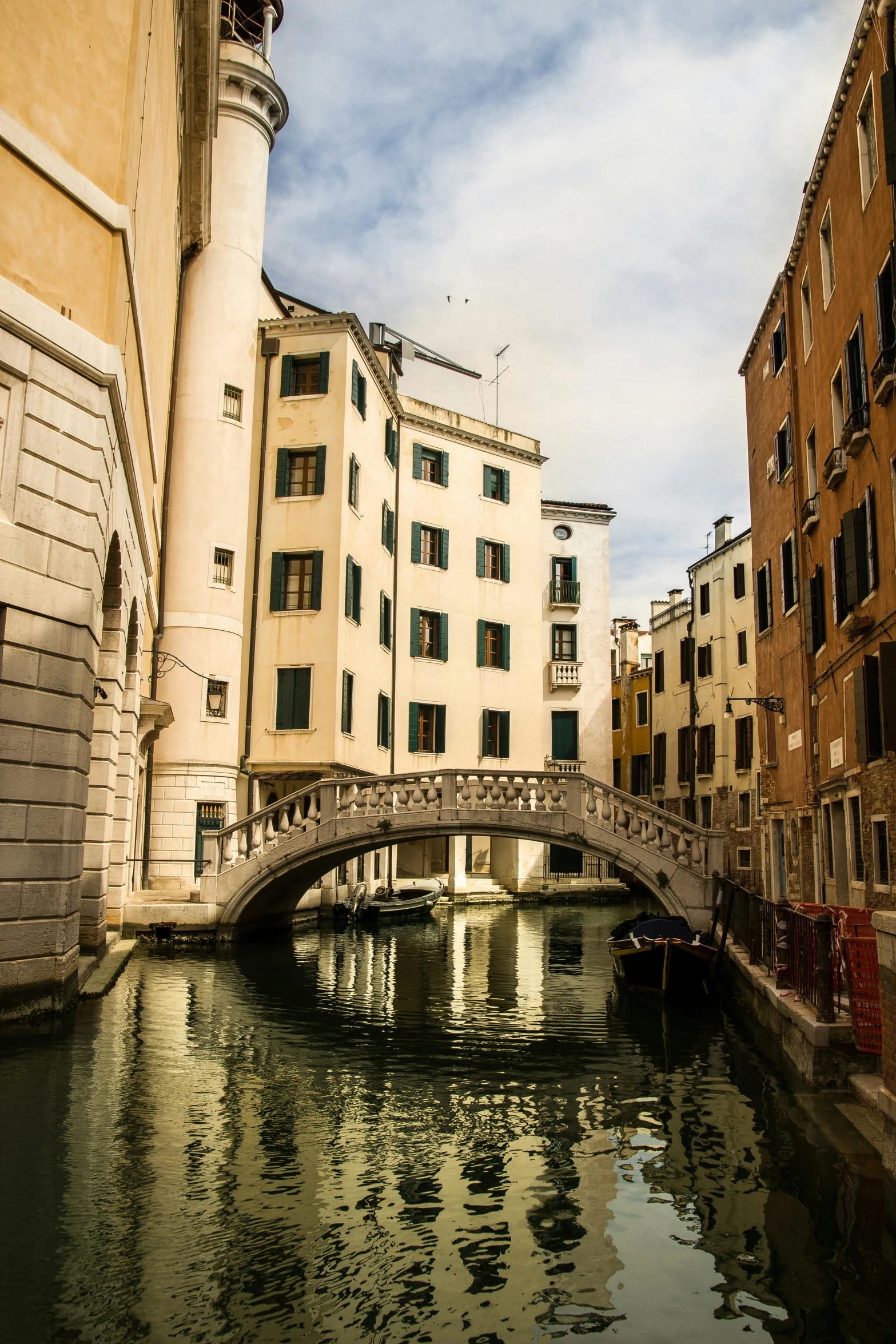 bridge over a canal leading to multiple buildings