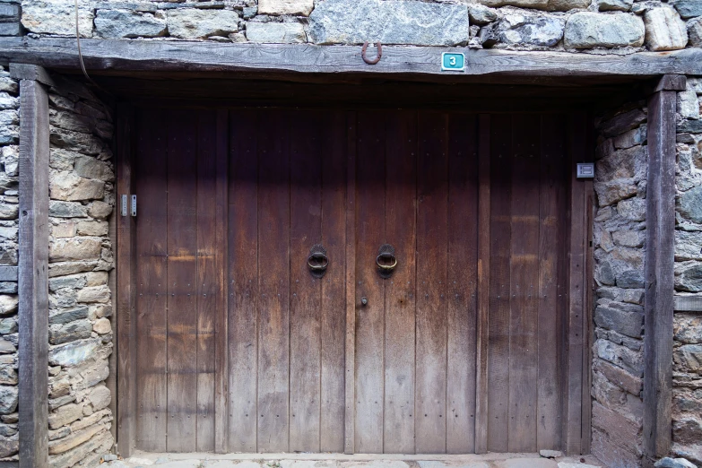the front doors to a small stone house