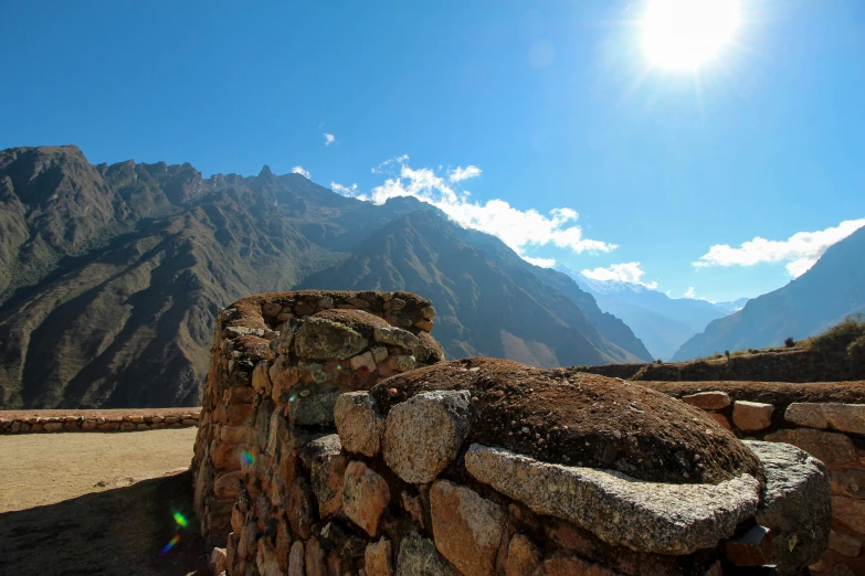 the view from a large stone wall in the mountains