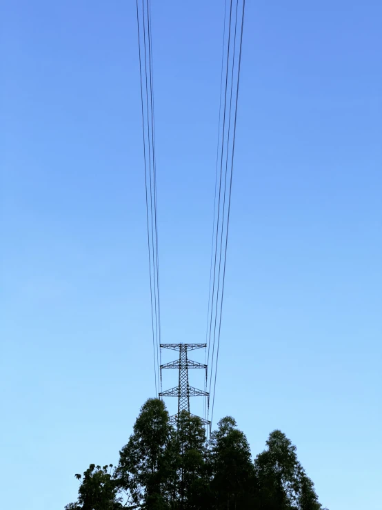 a row of power lines against a blue sky