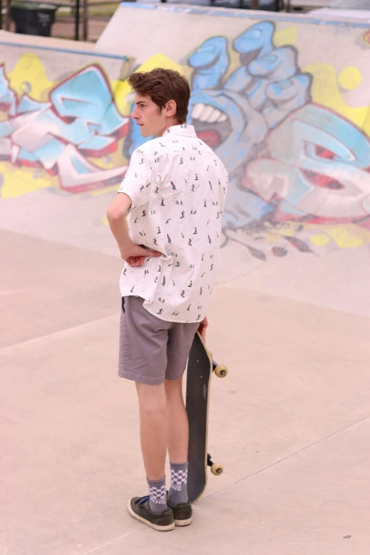 a young man with his skateboard at the skate park