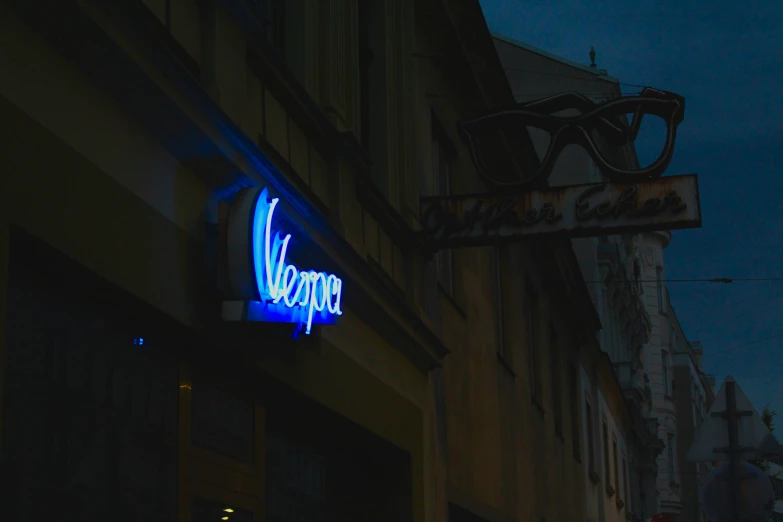 the neon neon sign is displayed for customers to welcome