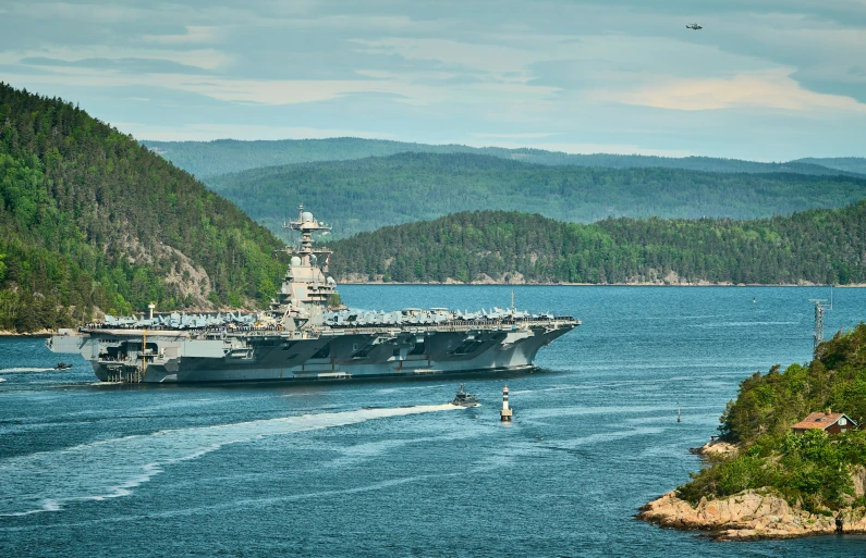 an aircraft carrier is coming into a landing area