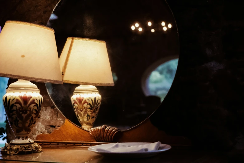 two vases are next to the mirror on the table