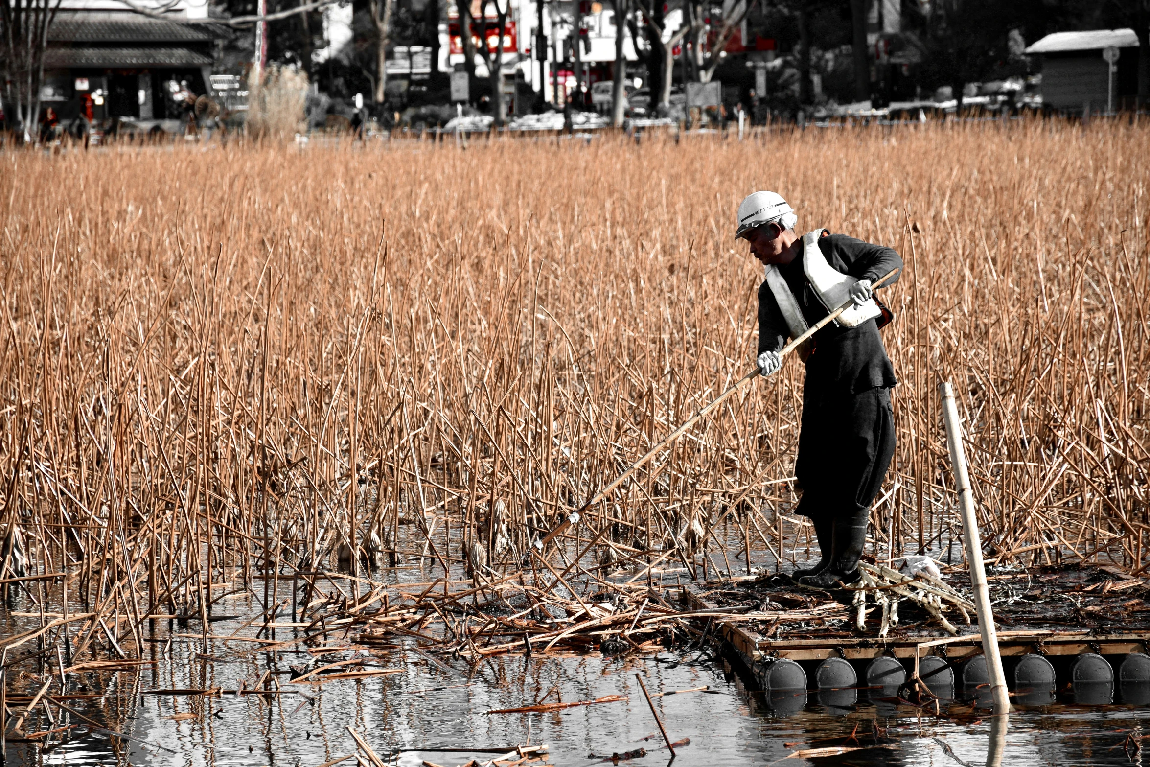 a man is standing on top of a raft in the middle of water