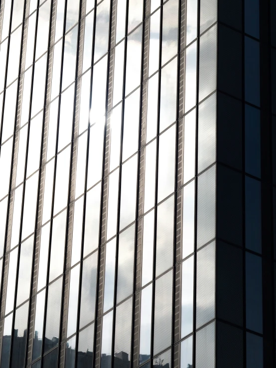 windows are reflecting clouds in a cloudy sky