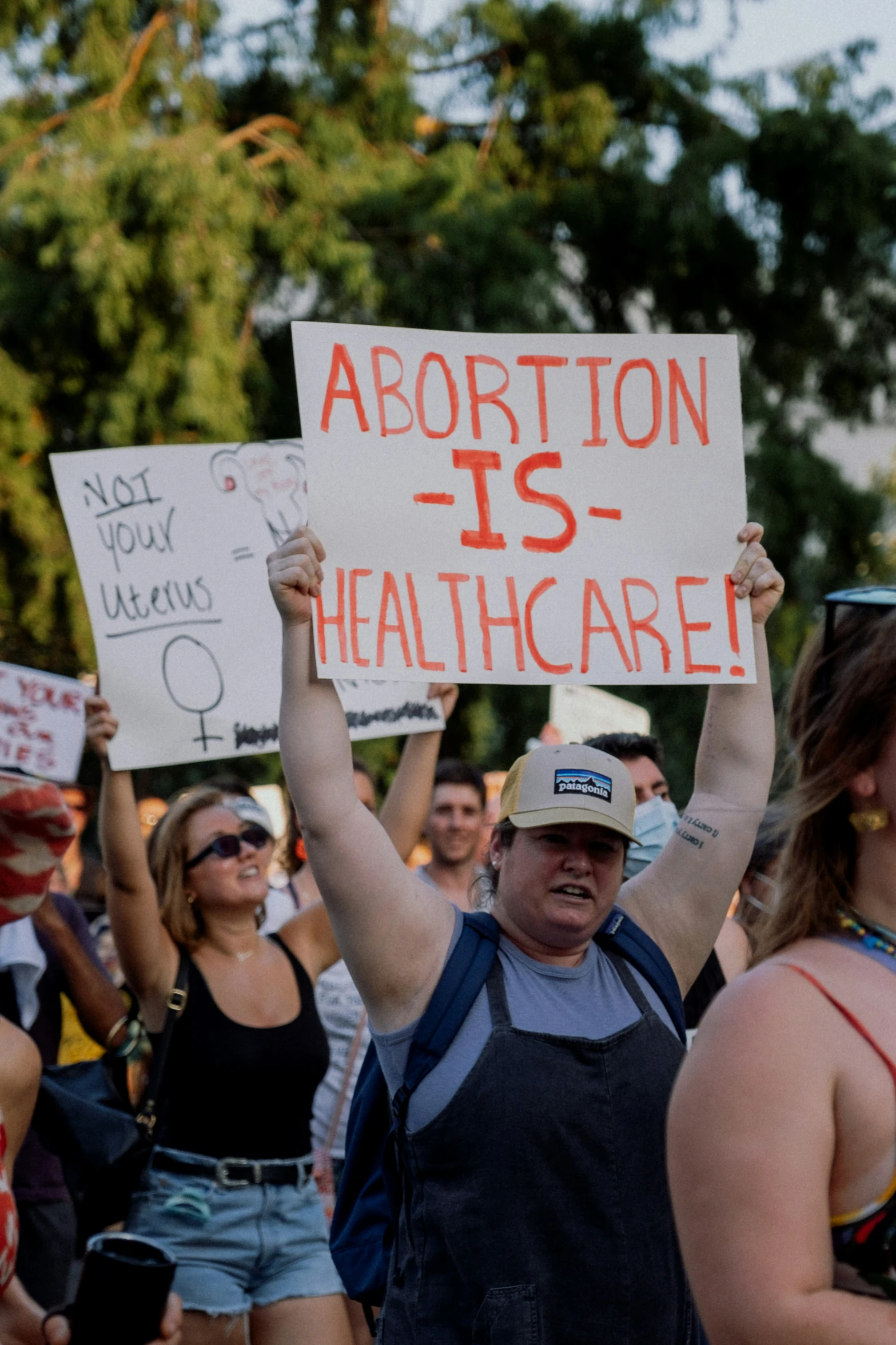 people are holding up signs during a protest