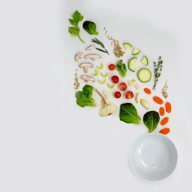 a bowl with vegetables and leaves in it