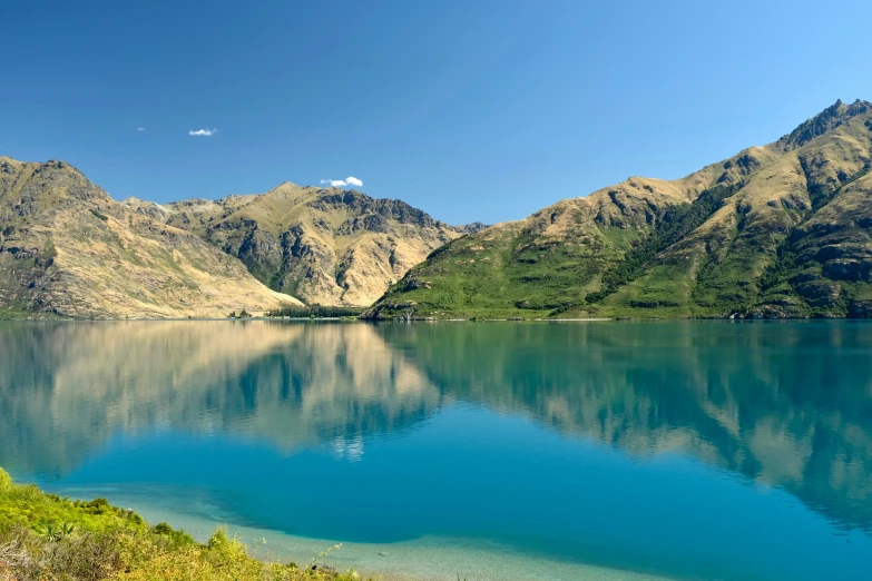 an alpine landscape with a lake surrounded by mountains