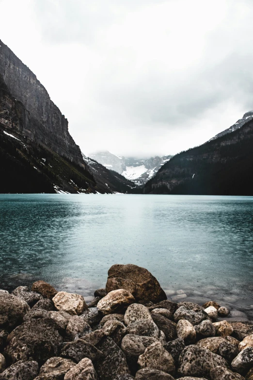 some rocks near some mountains and water