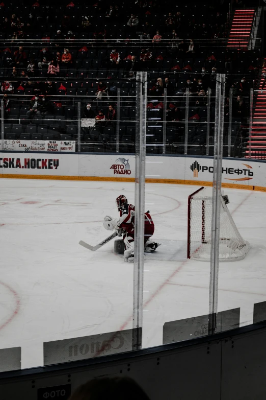 an empty hockey rink with fans watching a game