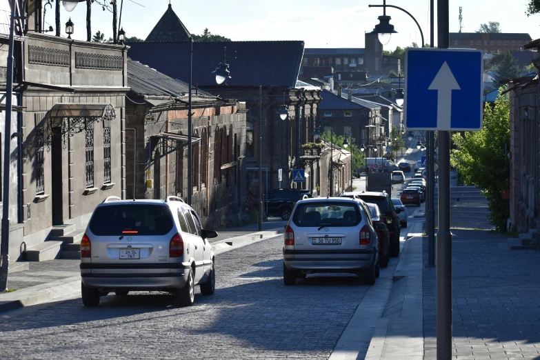 the view of a street with cars parked on it