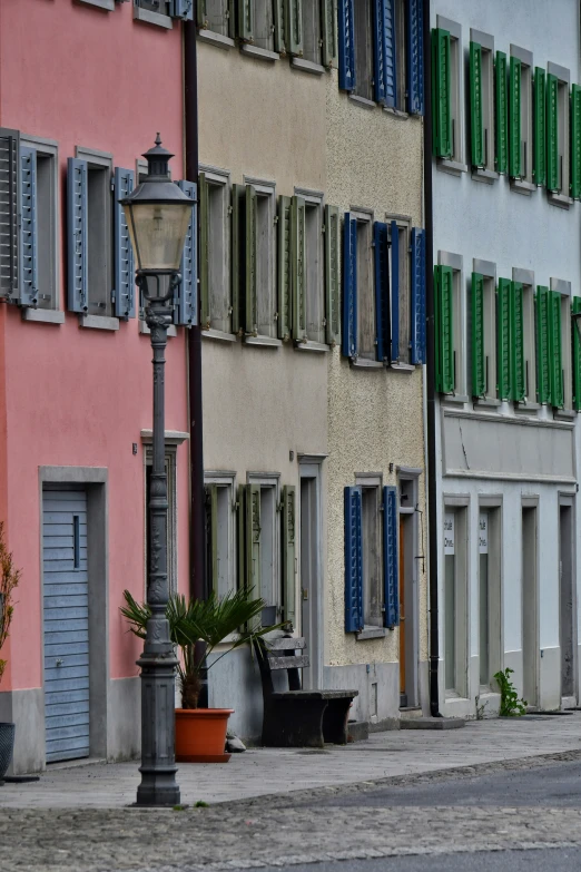 street lamp on sidewalk beside multiple colorful buildings