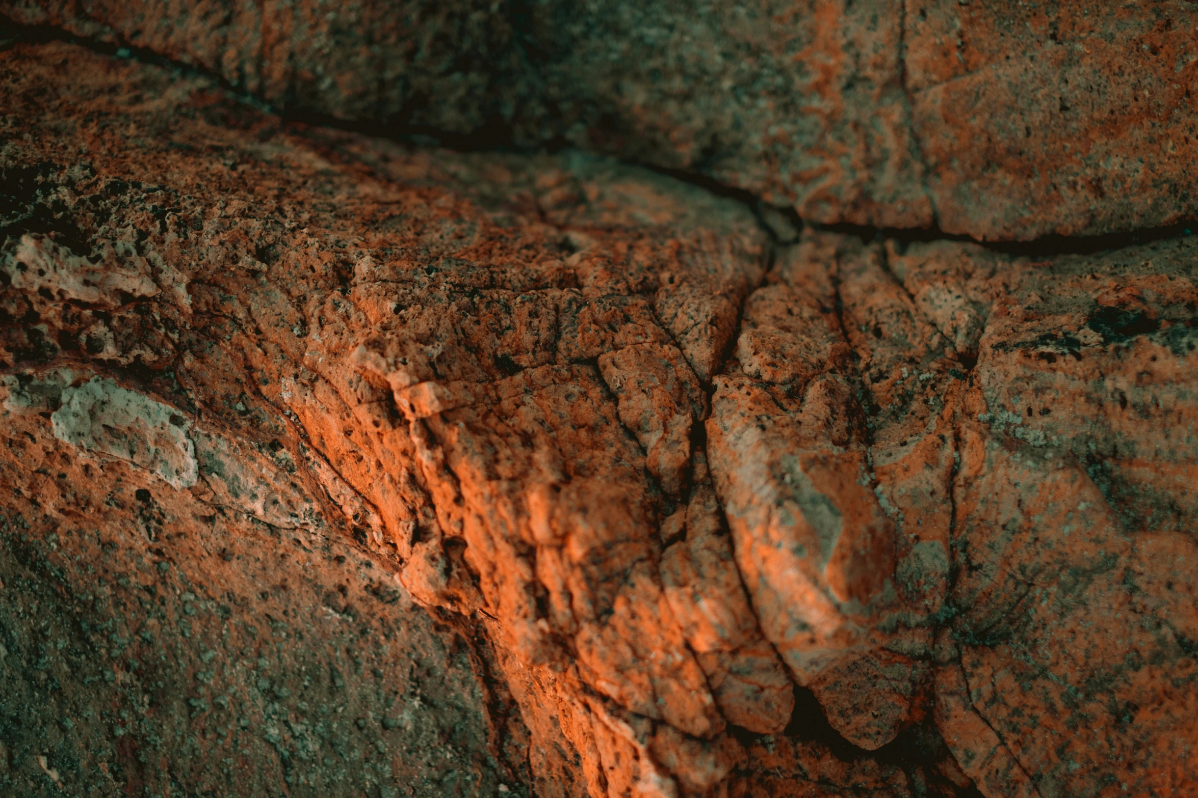 some red dirt on top of a big rock