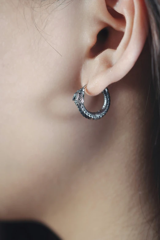 a close - up of a woman's ear with an intricate circle of cubicles around it