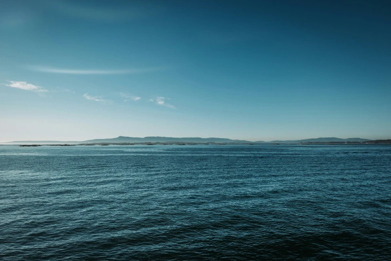 water, sky and mountain from the side of a boat