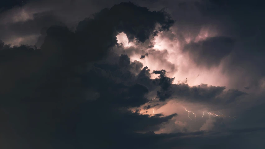 the sky and the clouds are stormy, the plane is in the foreground