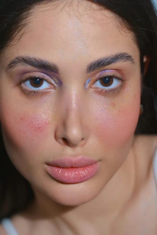 a woman with some pink and yellow face paint