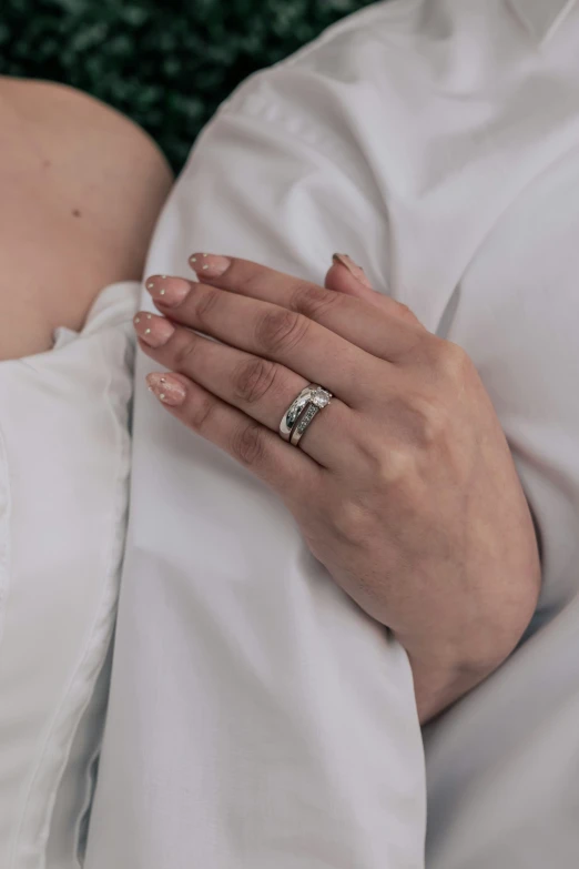 a person wearing a wedding ring in front of them