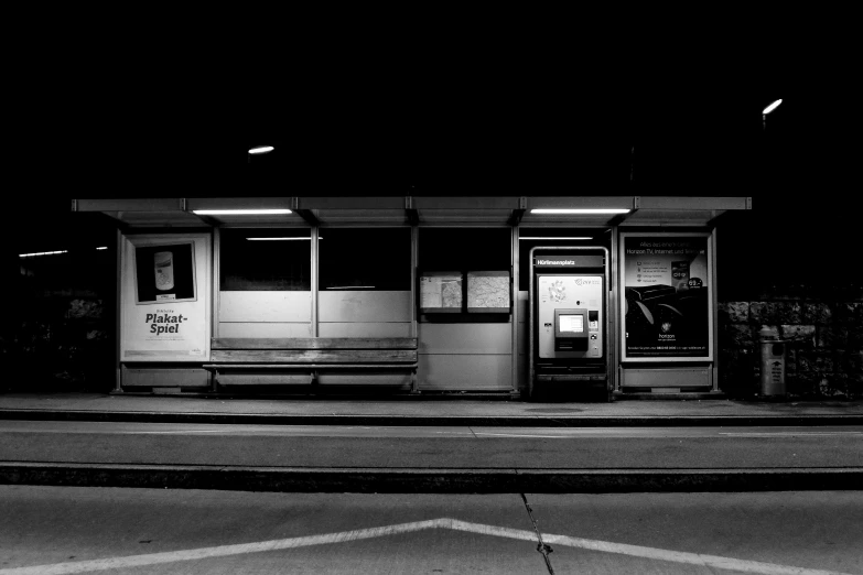 an empty building at night with light coming in from two doors