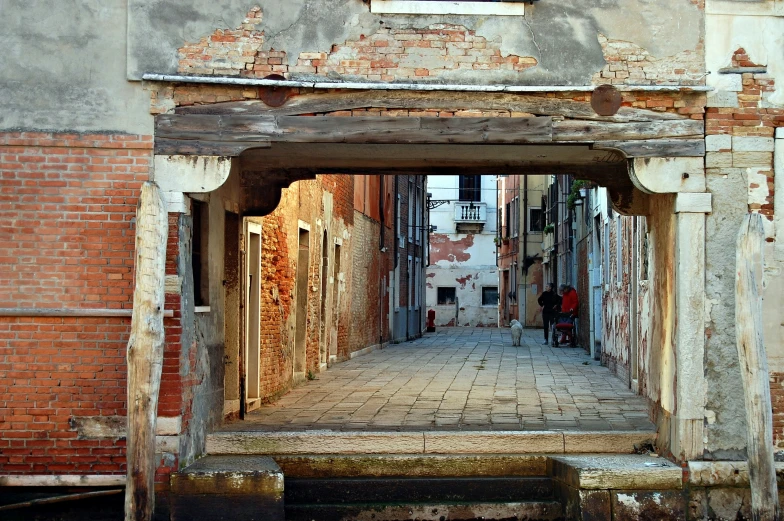 an old city street with people on the side walk