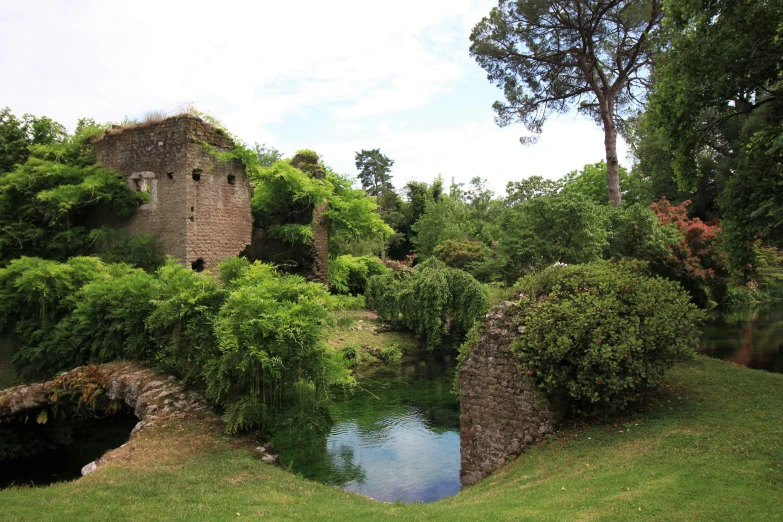 a stone bridge and house on a cliff