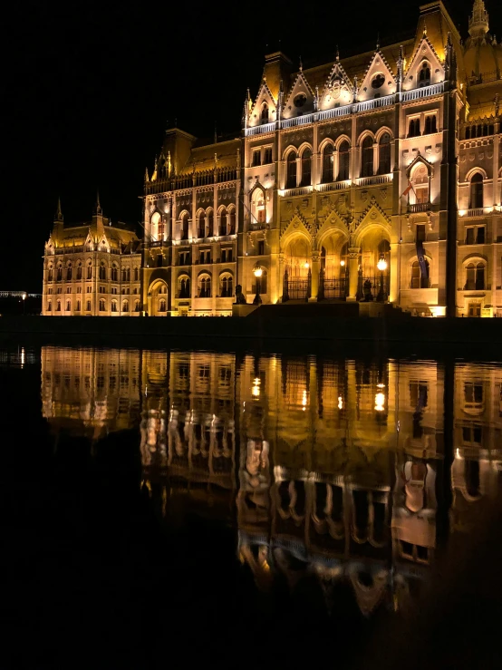 night time view of an ornate building reflecting on water