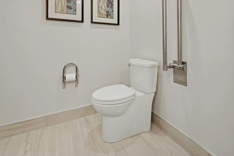 a white toilet and shower with wooden flooring