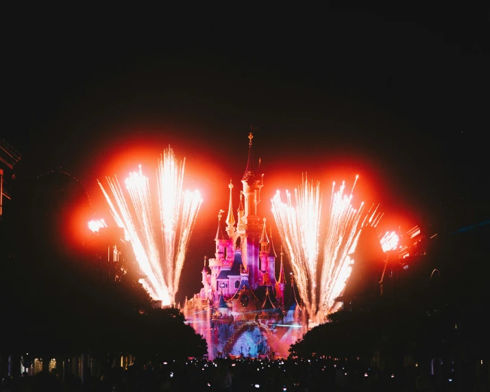 fireworks in the air above a large castle
