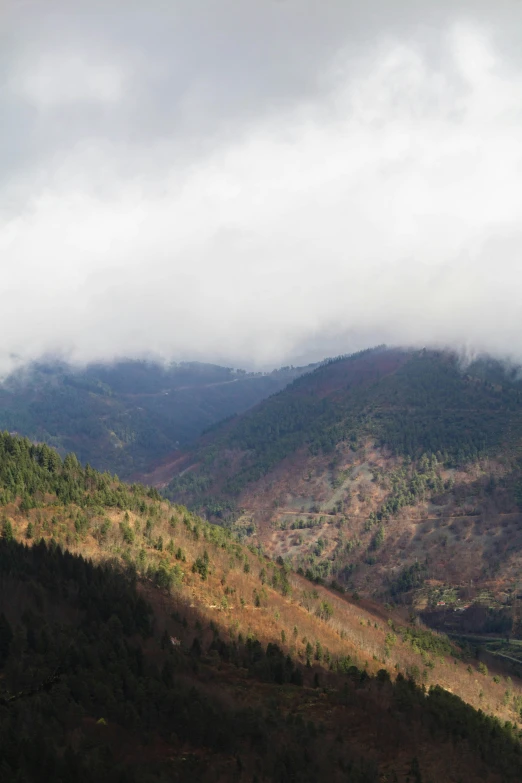 a group of mountains under a cloudy sky