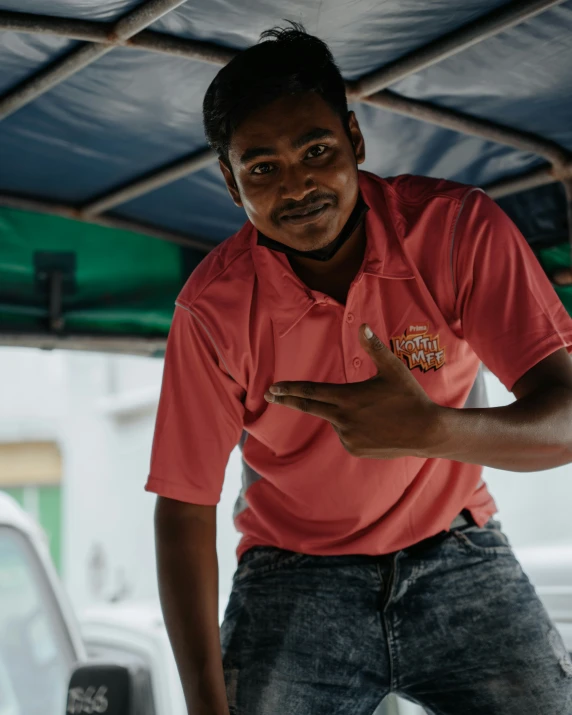 a man in red shirt holding soing and smiling