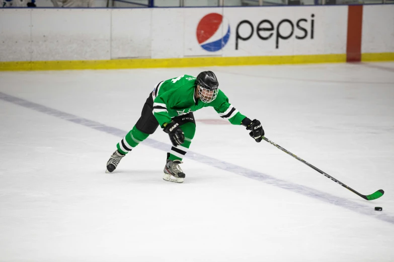 the hockey player is in green and white jersey