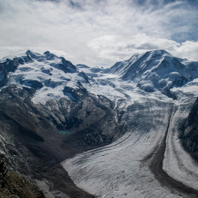 a glacier is snow capped mountains in a scenic landscape