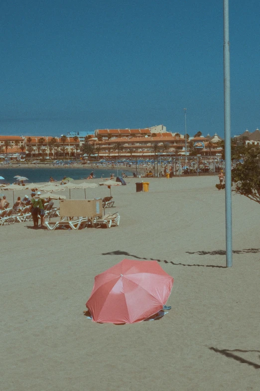 a beach with chairs and an umbrella