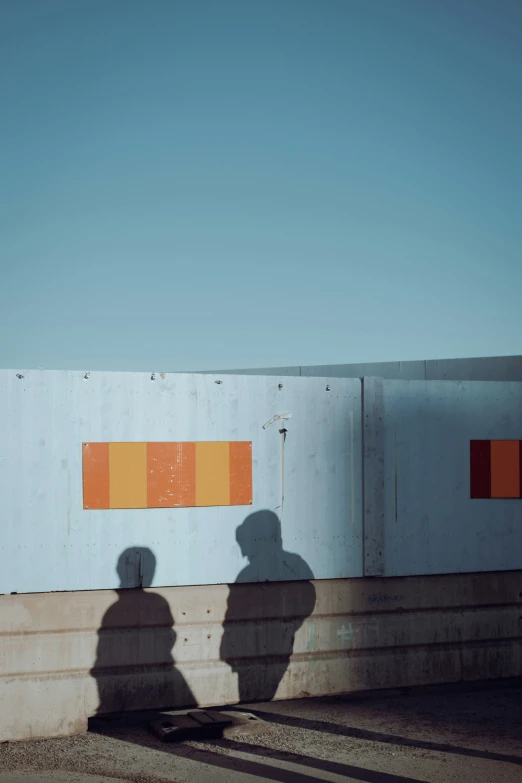 shadow cast on concrete with painted white walls