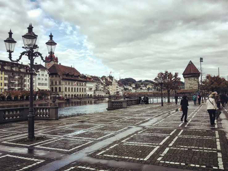 a city square and a canal are visible with some people in it