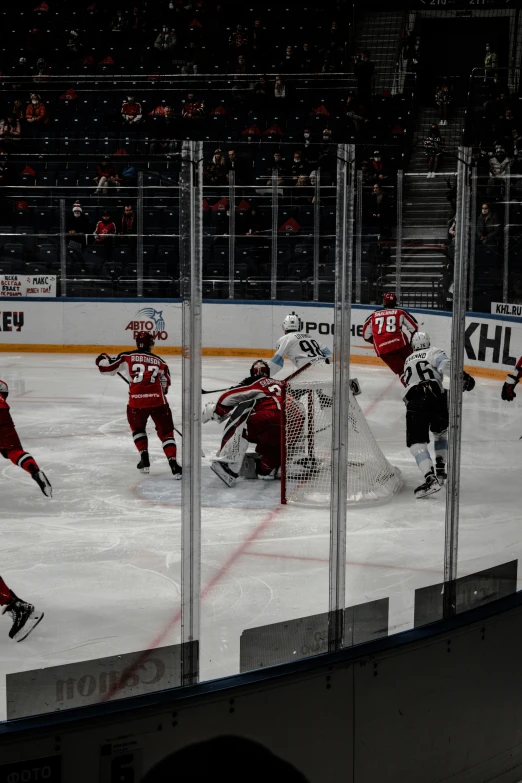 the hockey teams play on a rink with their arms in the air