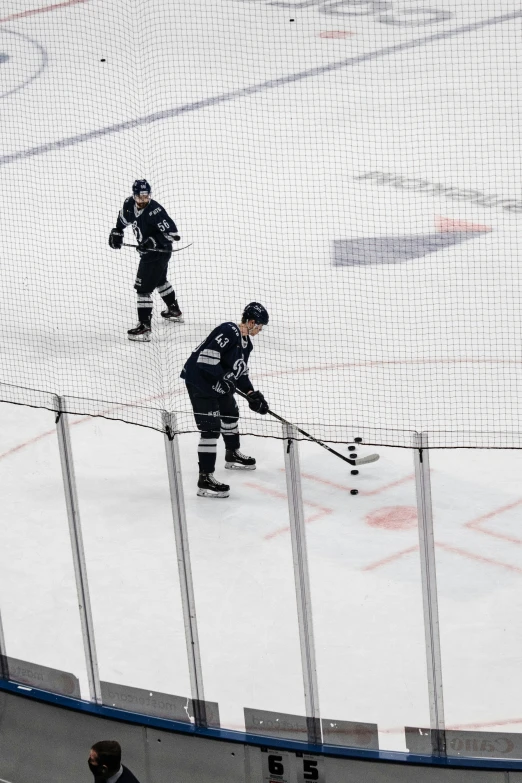 two hockey players play in an ice rink