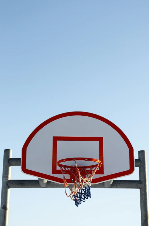 an outside basketball hoop with the basket still attached to it