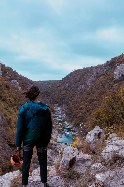 a person is standing on top of a hill